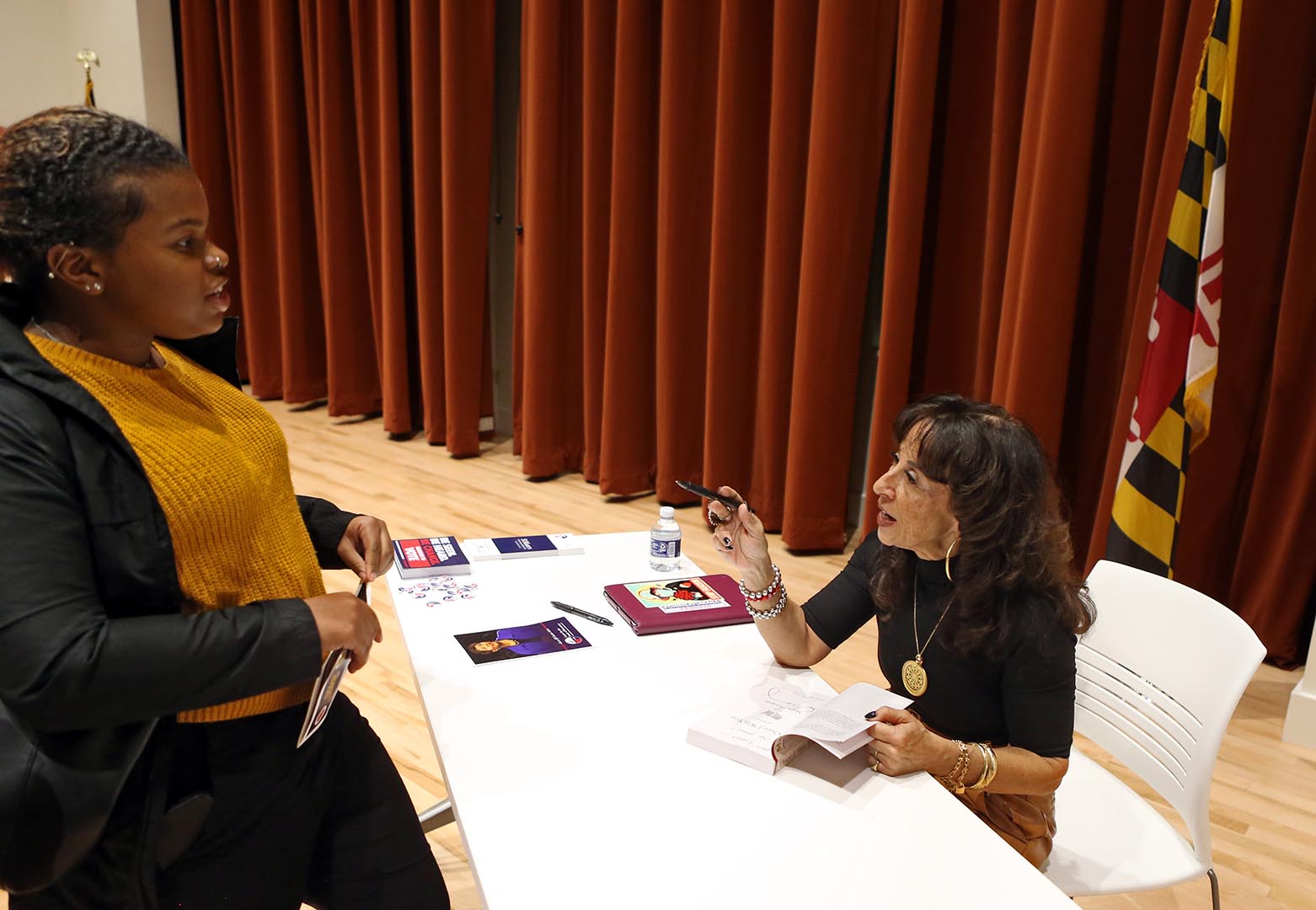   Maria Hinojosa signs a copy of her memoir after delivering the inaugural Gwen Ifill Lecture.