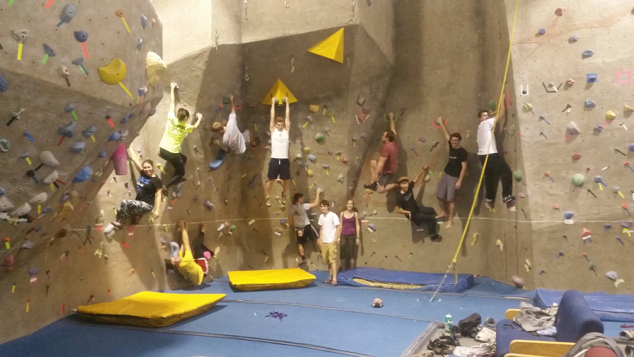 a group of college students on an indoor climbing wall