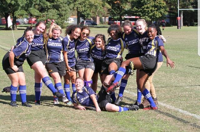 St. Mary's College women's rugby team poses for a picture on an outdoor football field