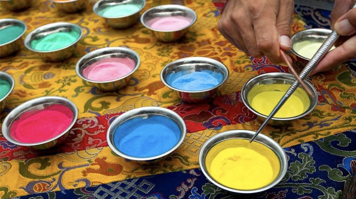 Bowls of the different colored sand used to create the sand mandala.