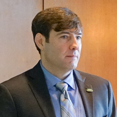 Andrew Cognard-Black presenting at a conference in 2015