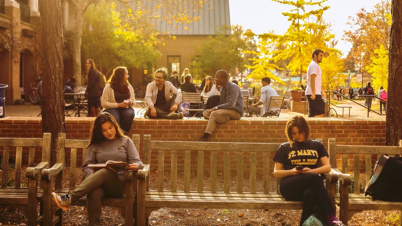 Students seated on campus center patio