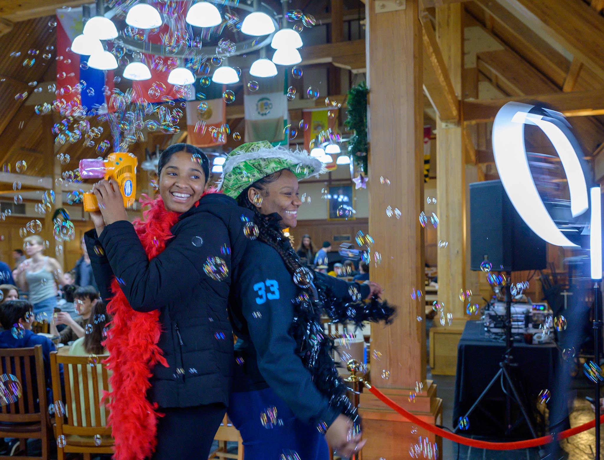 Two students pose in 360-degree video booth