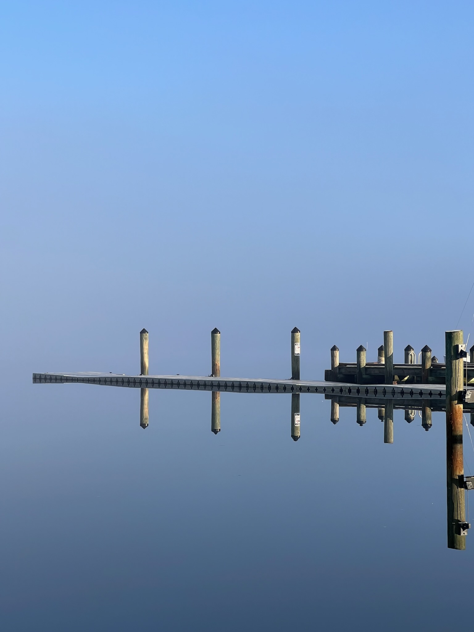 Dock and reflection in fog