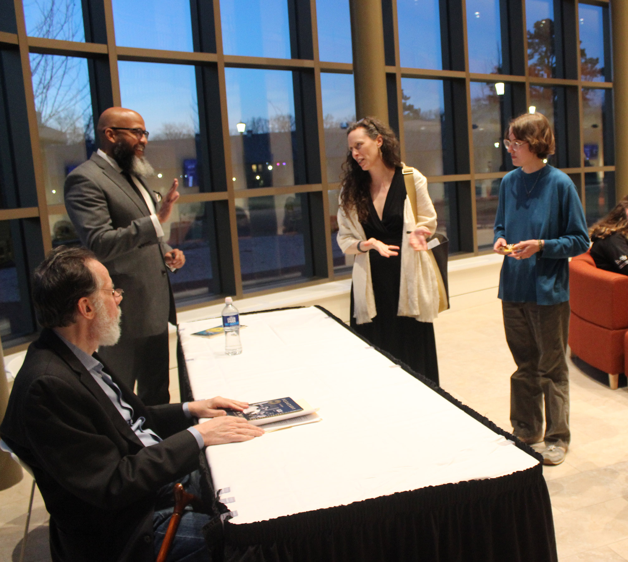 Poets John Murillo and Martin Espada are introduced by Poet Karen Leona Anderson to a student