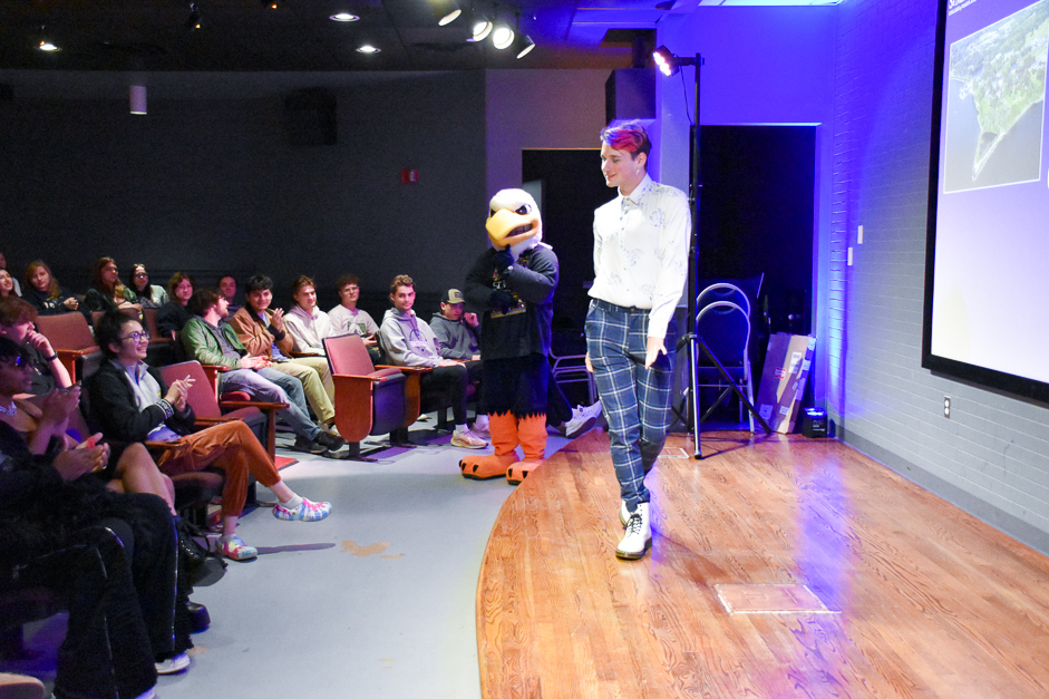 Gabe Cannanvo shows walks across stage at Cole cinema showing off business casual attire 