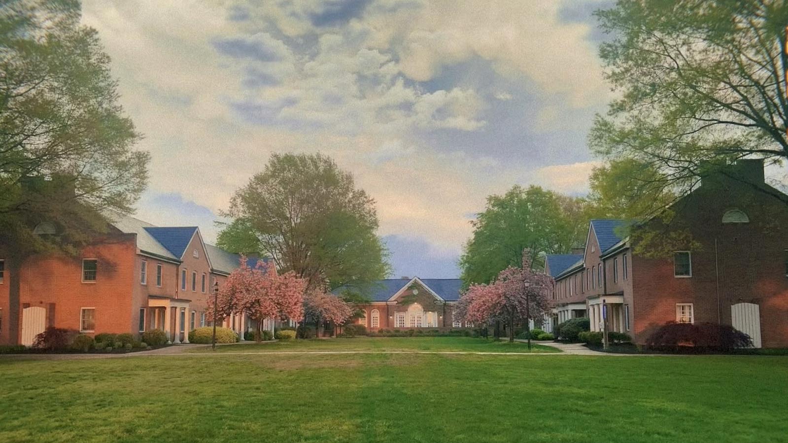 Photos of buildings on the green with trees and golden-tinged sky