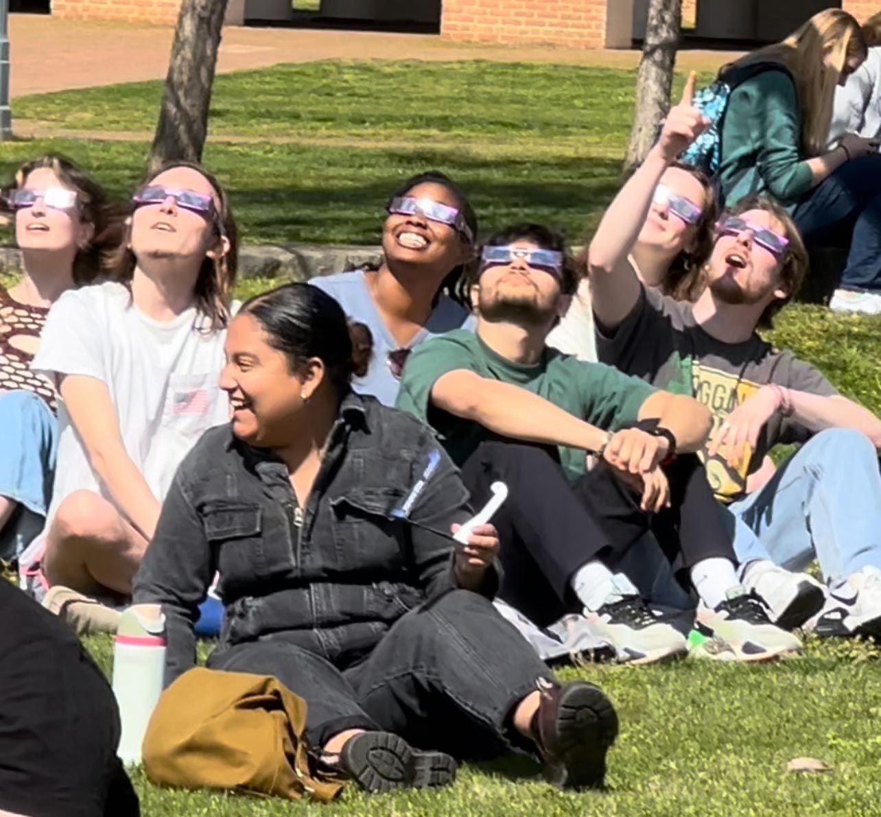 People looking up wearing eclipse glasses