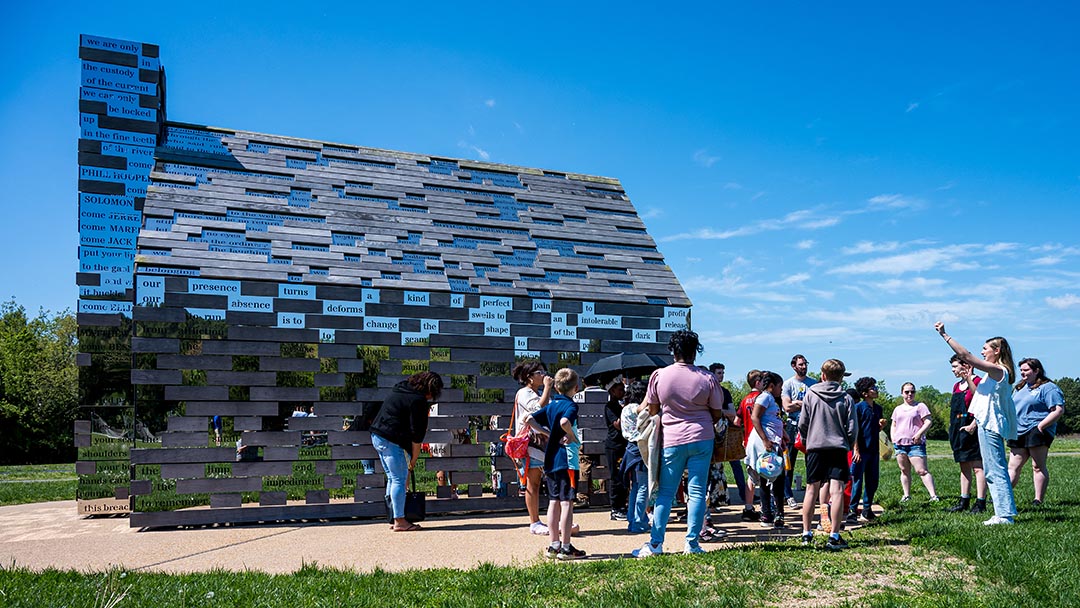 Students gathered around the Commemorative to Enslaved Peoples of Southern Maryland