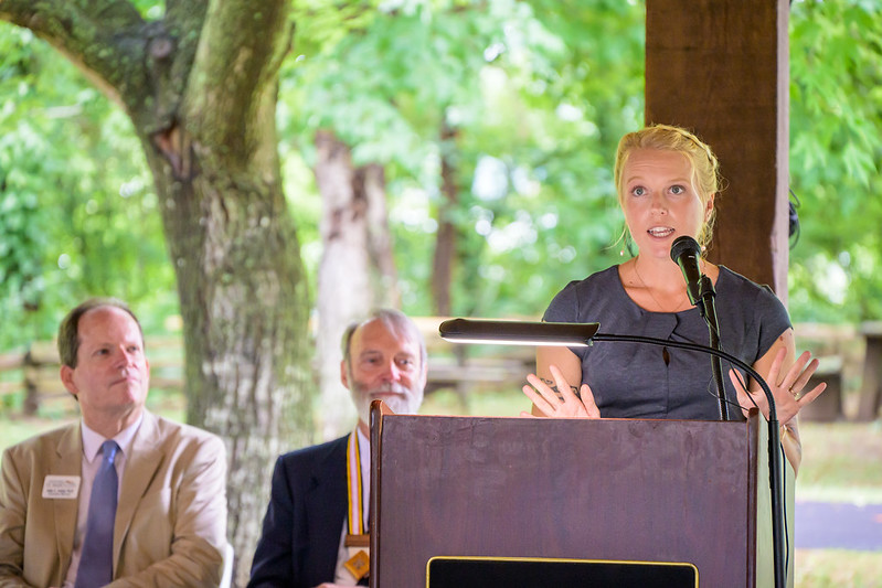 woman speaks at podium 