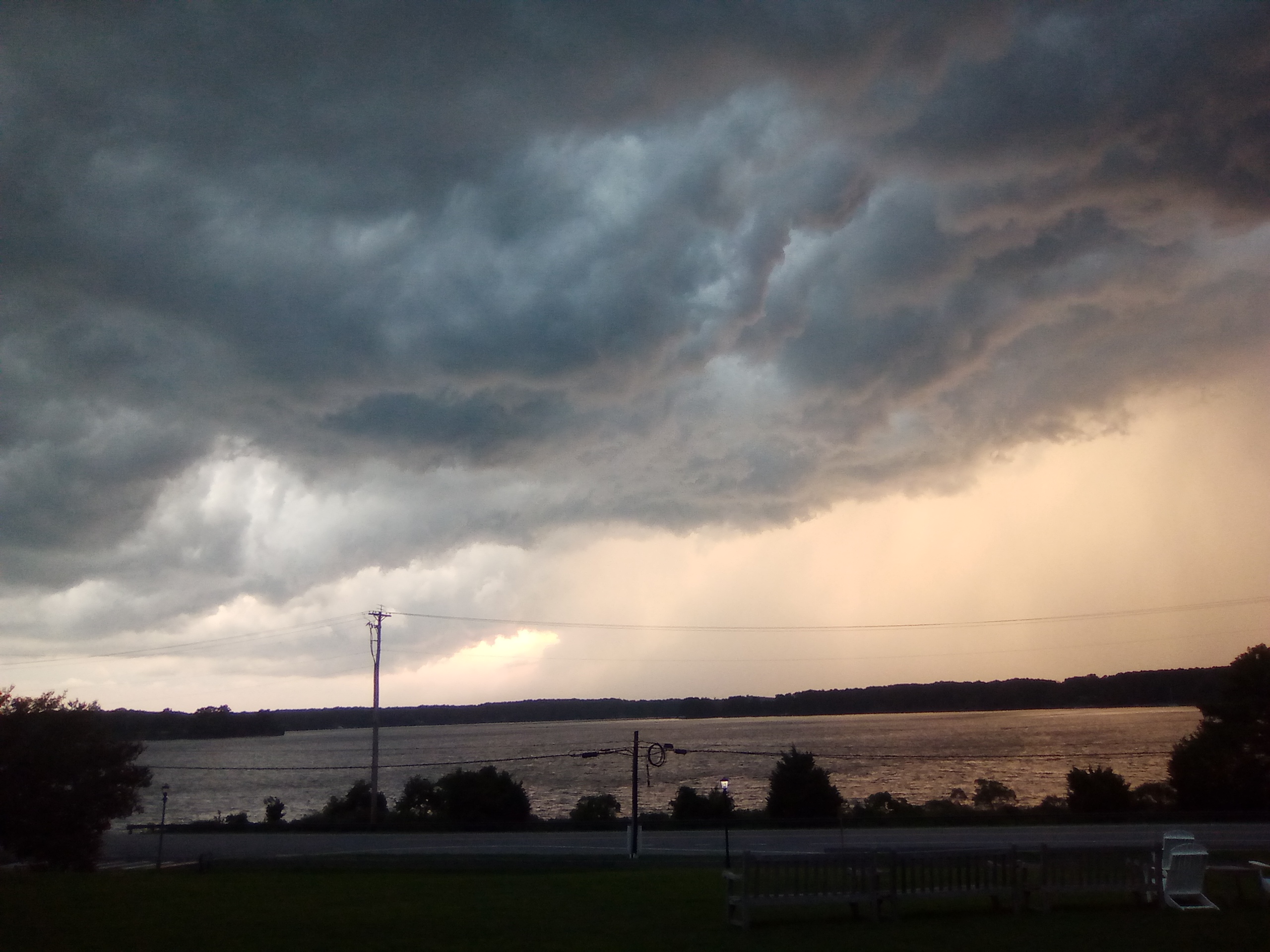 minutes before a heavy thunderstorm and dusk overlooking a river