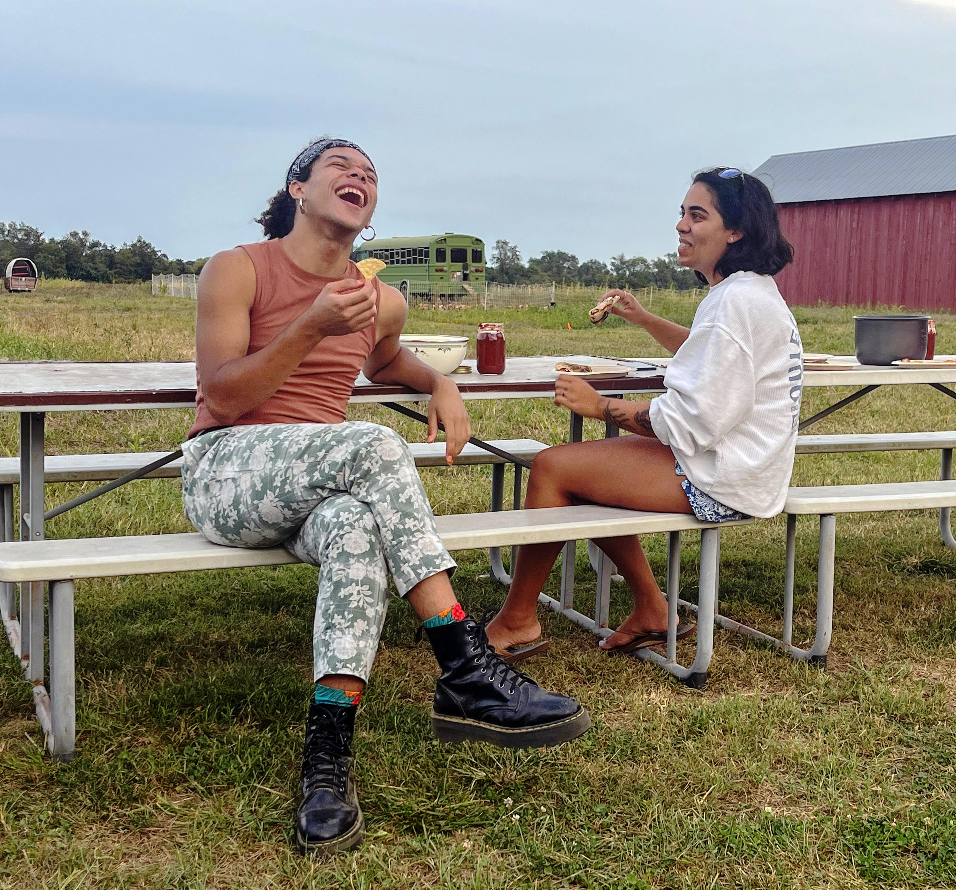 Two students enjoying pizza at Kate Farm 