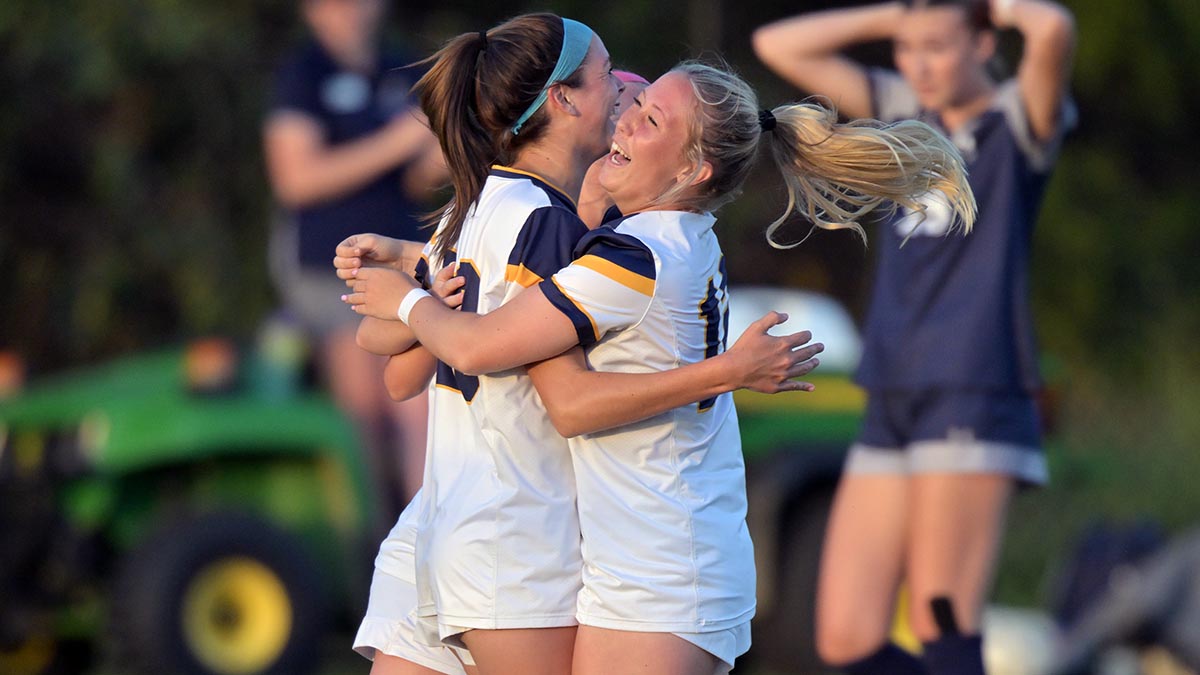 Soccer players celebrating a goal