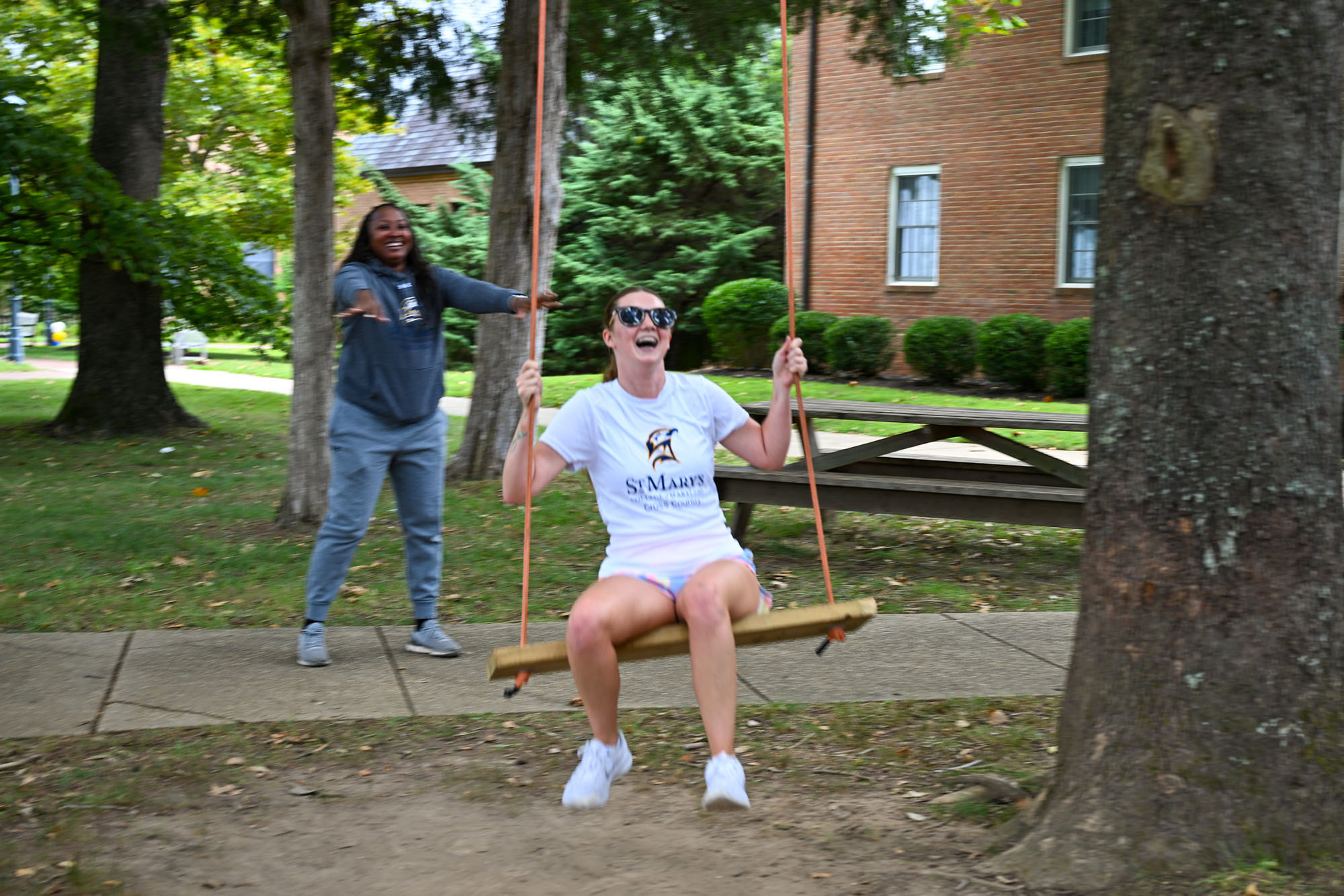 Alexis Hodges being pushed on the swing by Coach Potter