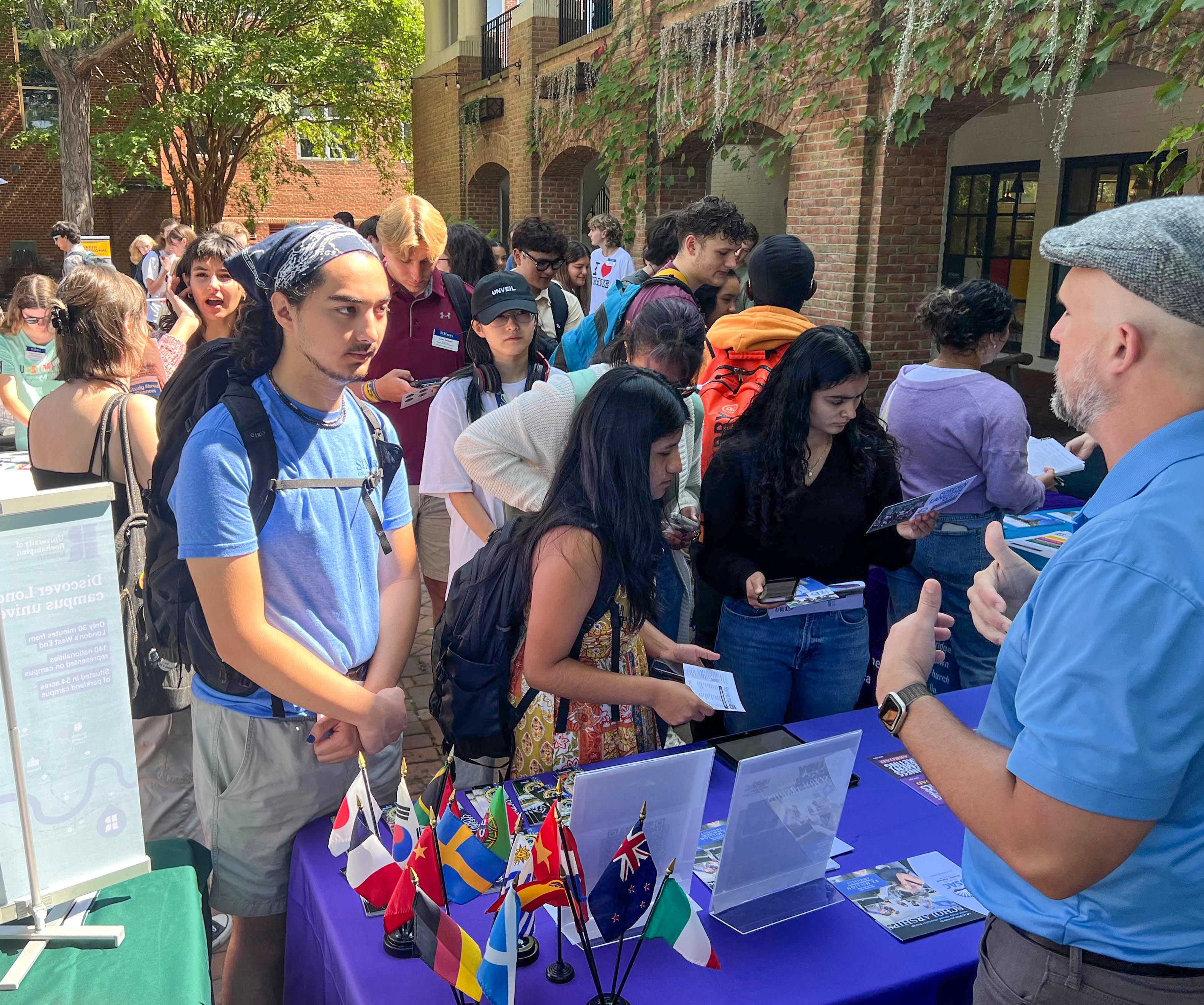 Students gather for study abroad fair on campus center patio 