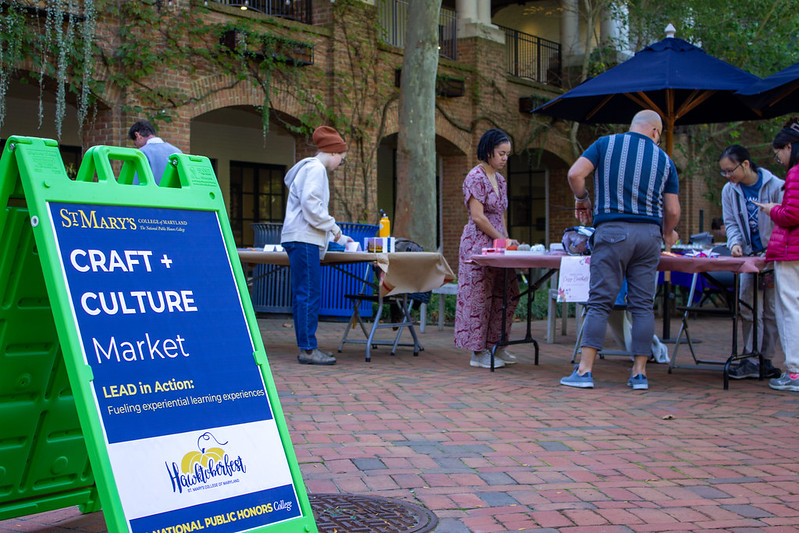 Students selling craft at tables on the Campus Center Patio