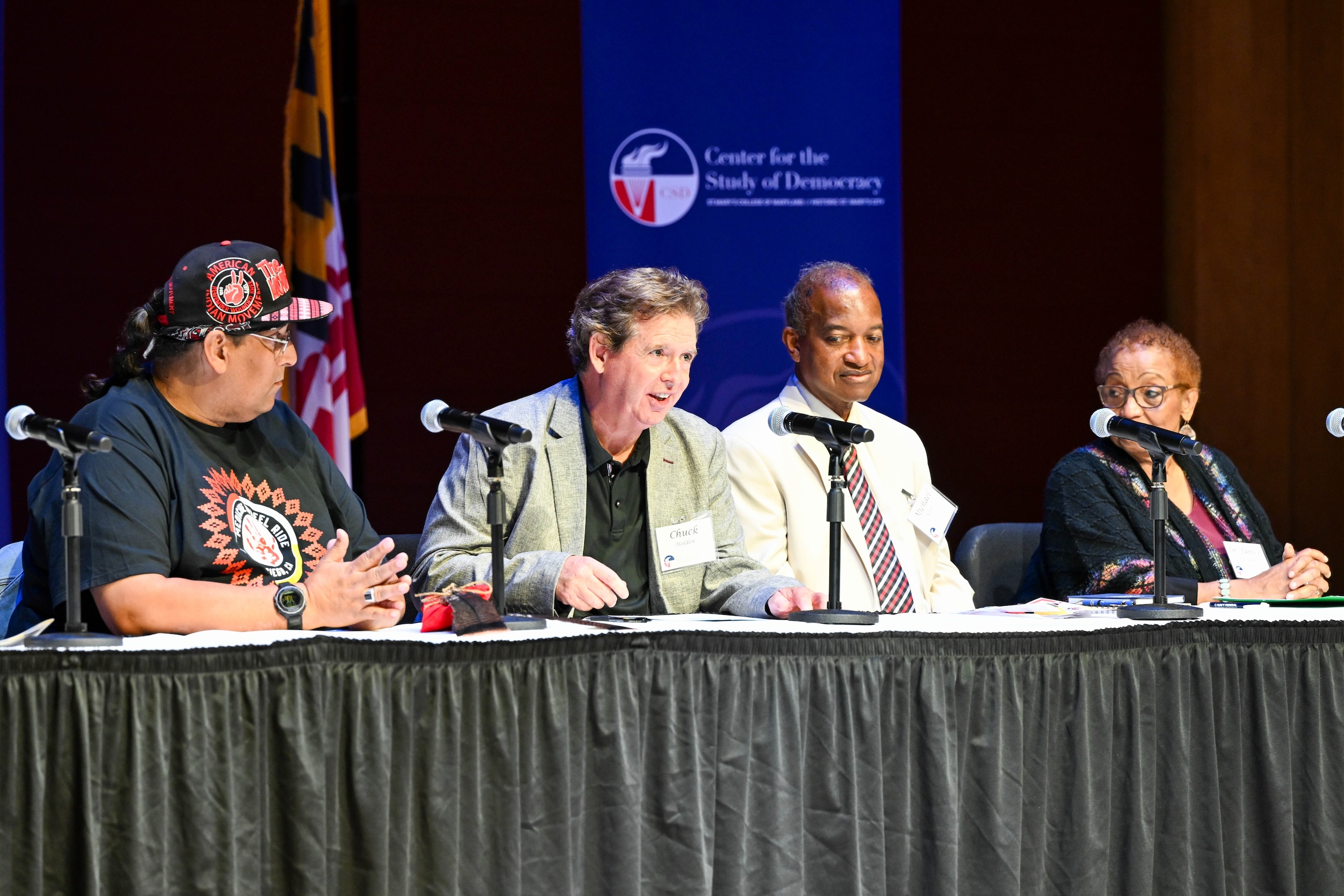 Panelists on a stage speaking on civil rights