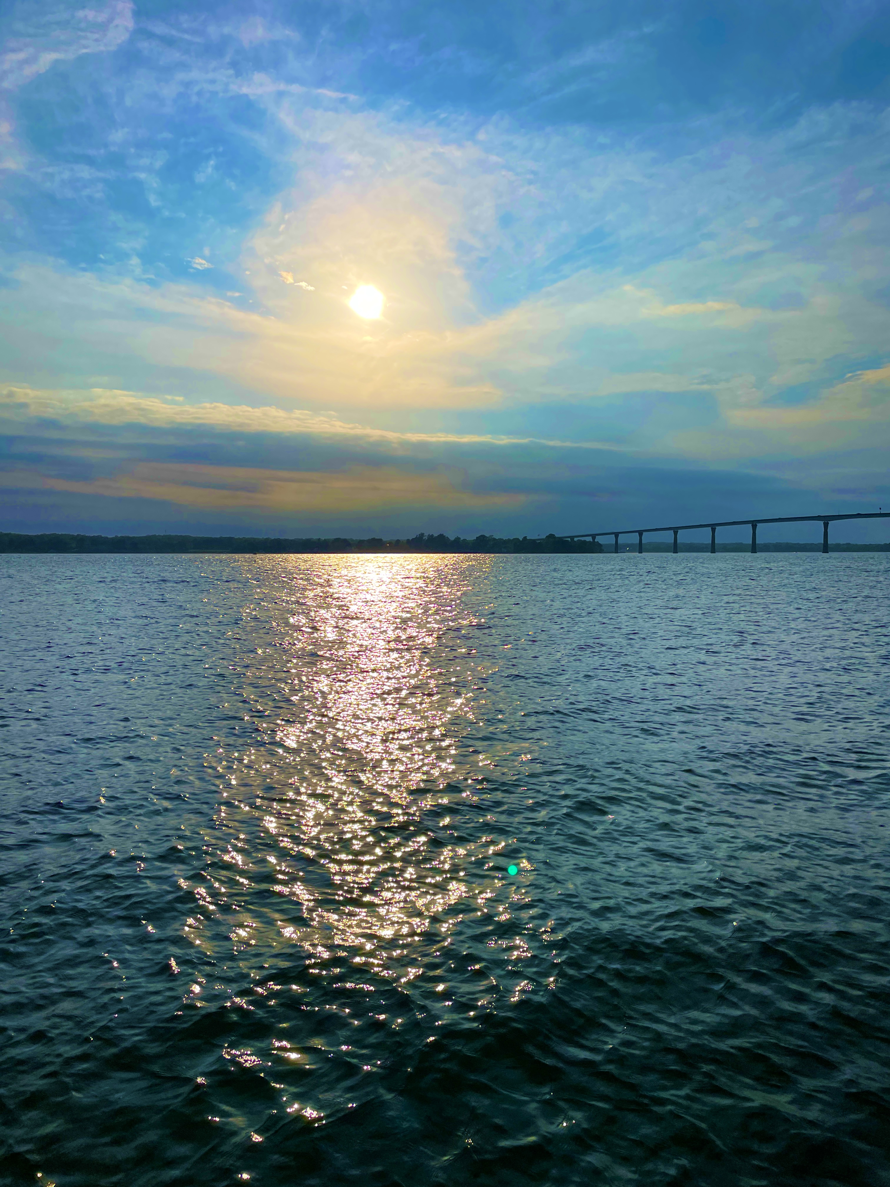 Sun reflection on water in Solomons Island with the Gov. Thomas Johnson Bridge in the background.