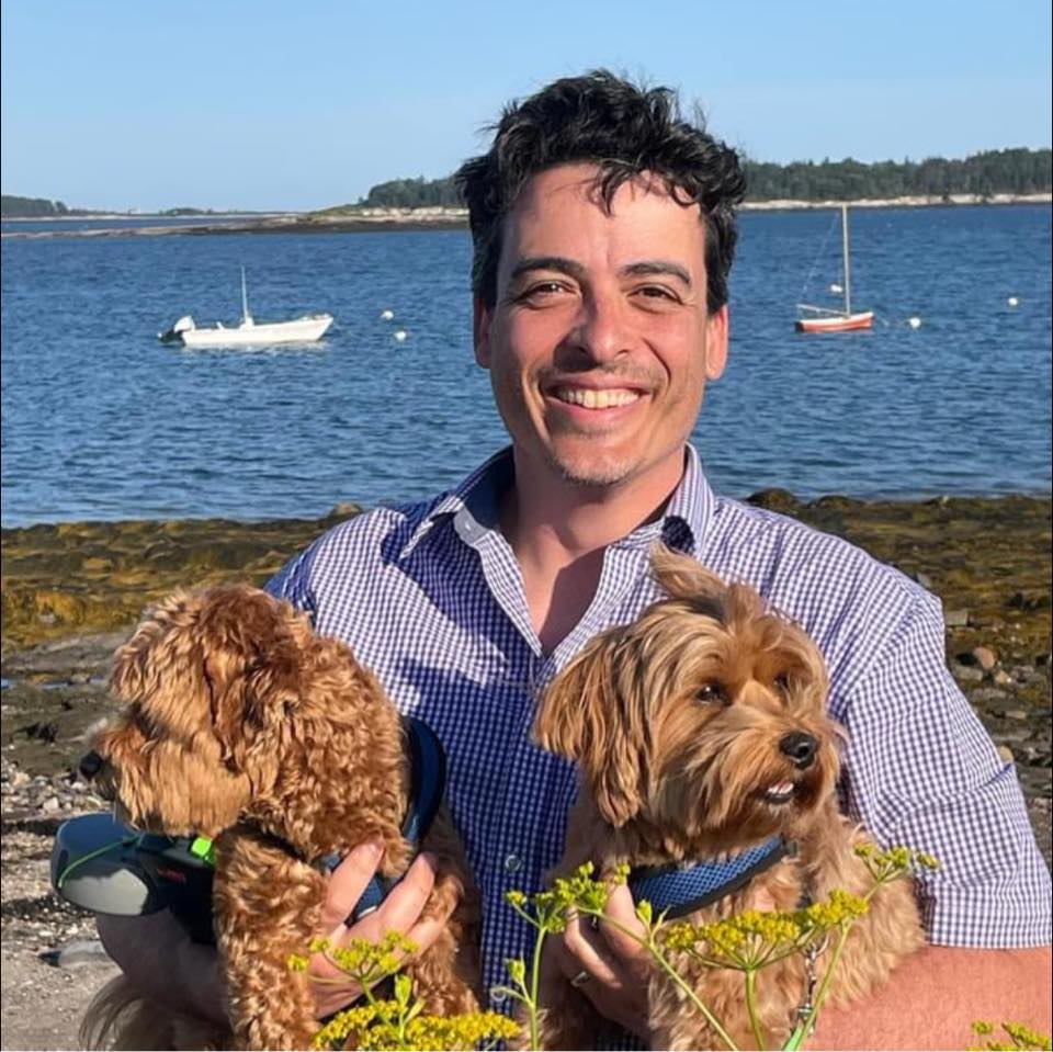 Dr. David Morris with his two dogs in front of the lake