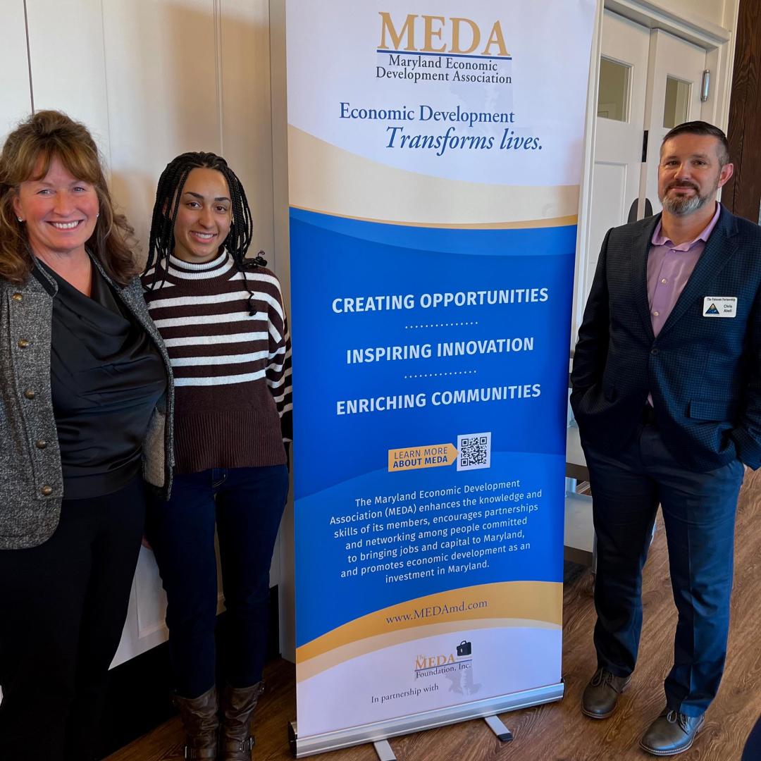 Cindy Greb, Daisha Jones, & Chris Abell stand next to MEDA banner