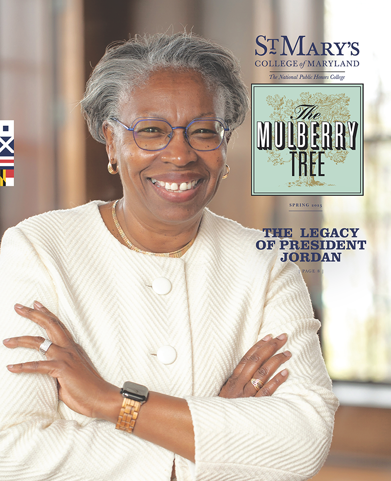 President Jordan stands smiling with arms crossed. Text reads, “St. Mary’s College of Maryland – The Legacy of President Jordan.”.