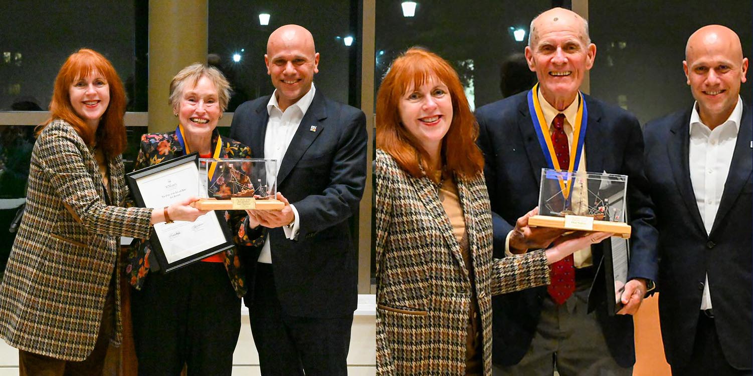 Four people pose indoors; on the left, a woman holds an award and another holds a certificate. On the right, the same woman presents the award to an older man with a medal.