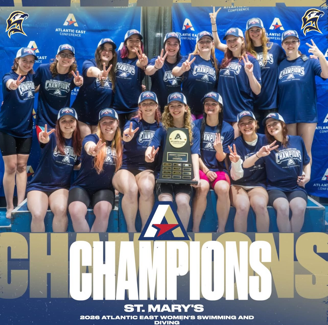St. Mary’s women’s swim team poses with a championship trophy and medals in front of a branded backdrop, celebrating their 2026 Atlantic East Conference win.