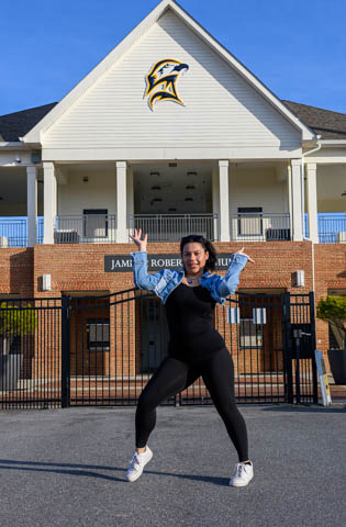 Kailah Callaham dances in front of the Jamie L Roberts Stadium 