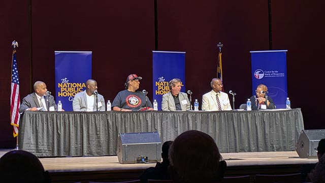 Panelists on stage at event