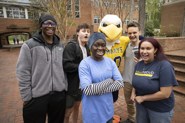 Group of SMCM students with the mascot, Solomon the Seahawk, outside on the Campus Center patio