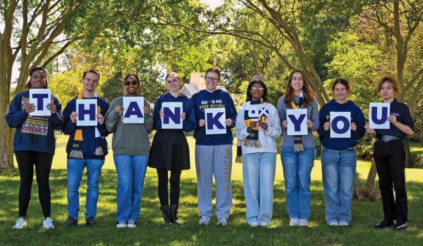 SMCM students standing outside holding up letters that spell Thank You