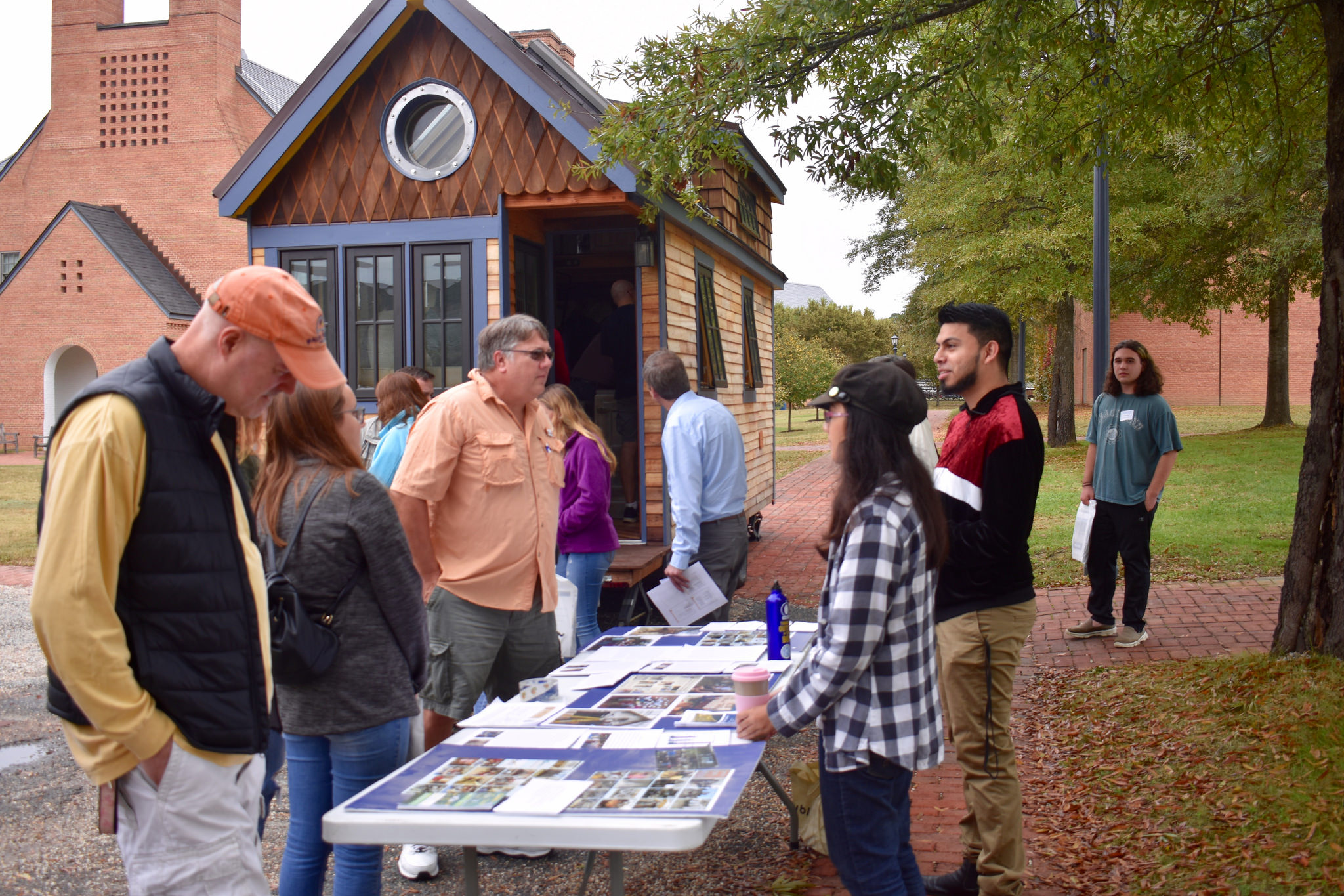 Students welcoming prospective students and parents at the Tiny House displace