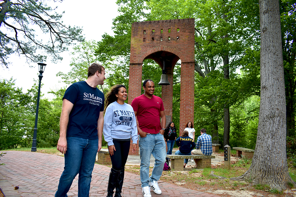SMCM students walk by the bell tower on campus 