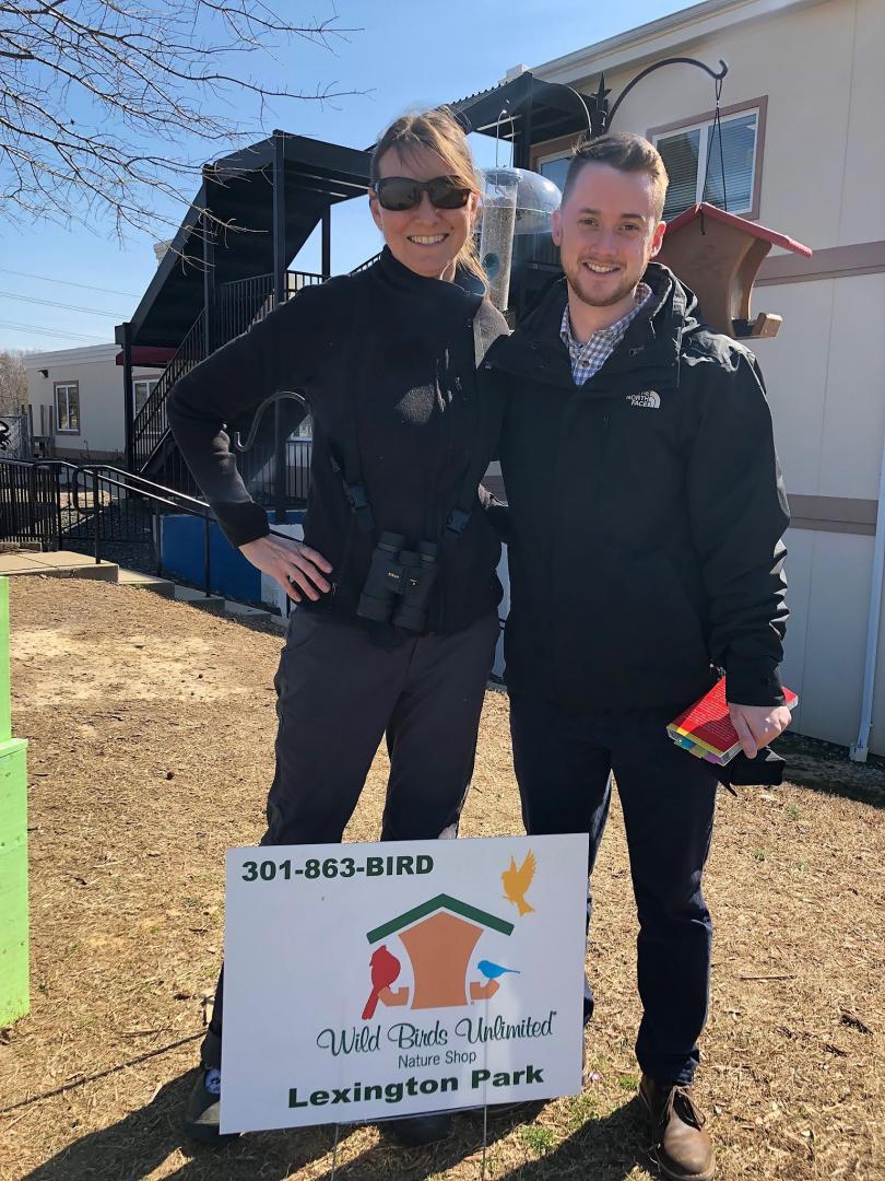 Assistant Professor Jessica Malisch and Derrick May stand by the bird feeders donated by Wild Birds Unlimited Lexington Park for Project FeederWatch at the Chesapeake Public Charter School