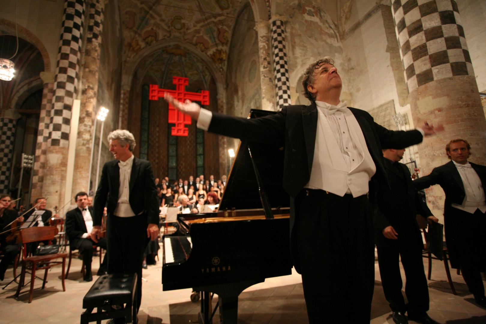 Pictured: A previous performance by Brian Ganz, left, at the Alba Music Festival in Alba, Italy, conducted by Larry Vote, center.  