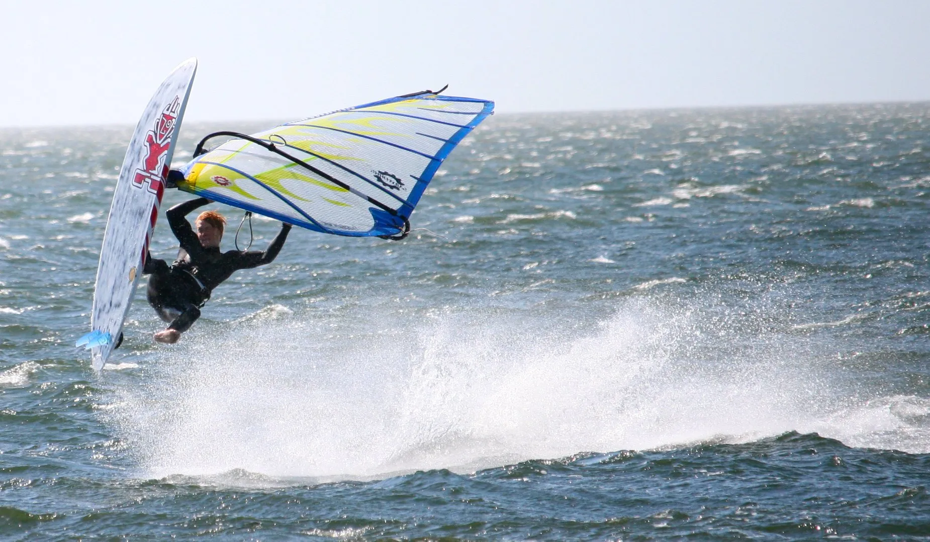 A St. Mary's College student windsurfing on the St. Mary's river on a sunny day.