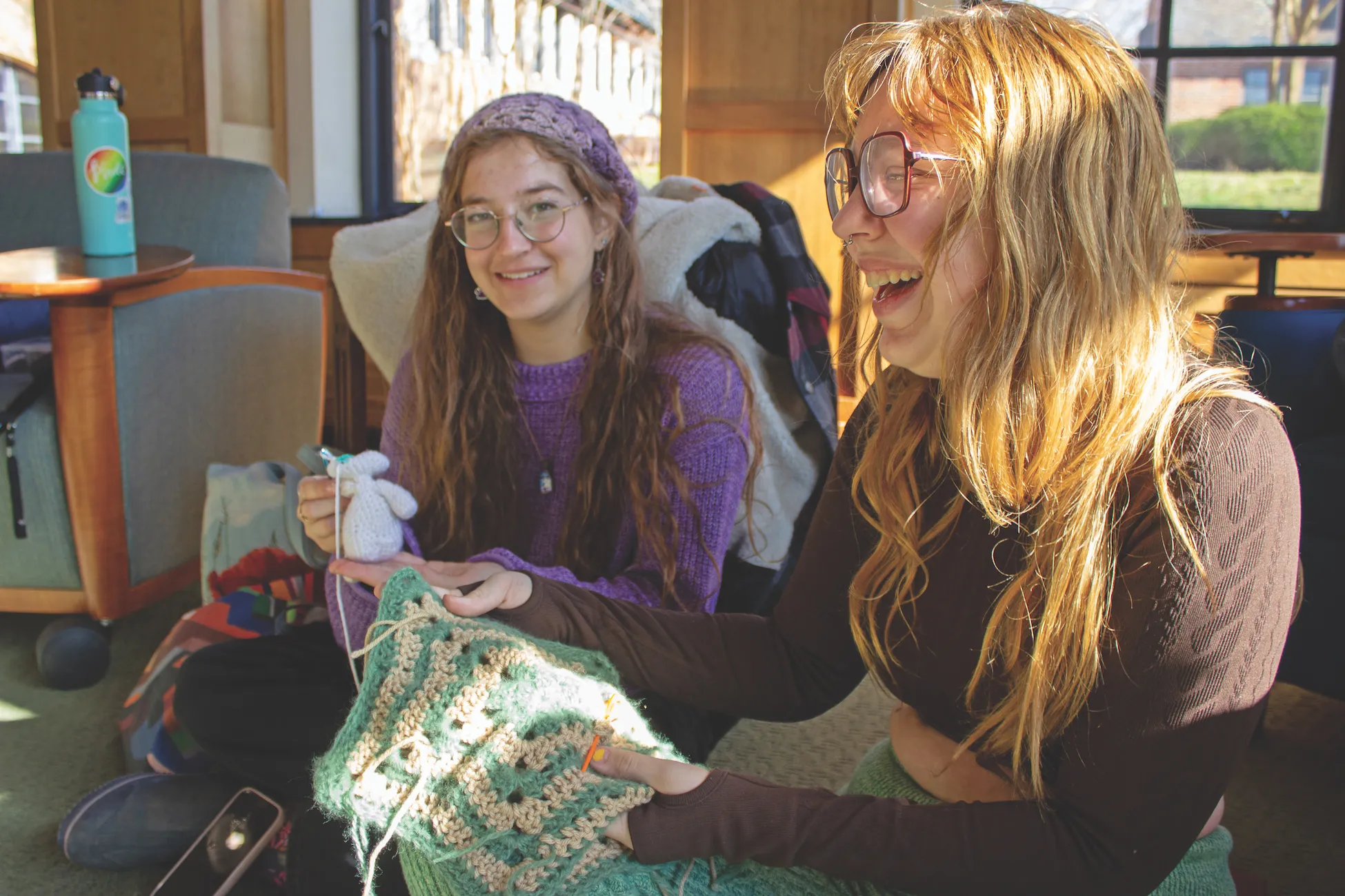 Two students knitting happily