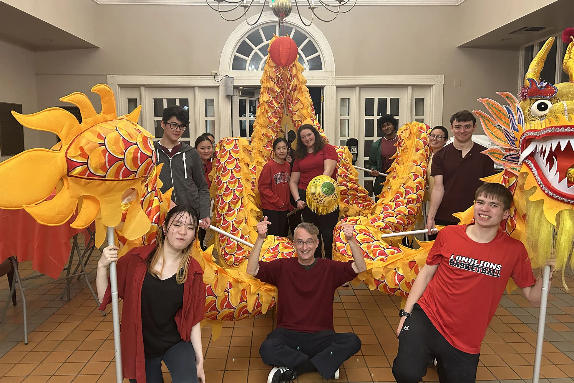 Several students posing with a Dragon