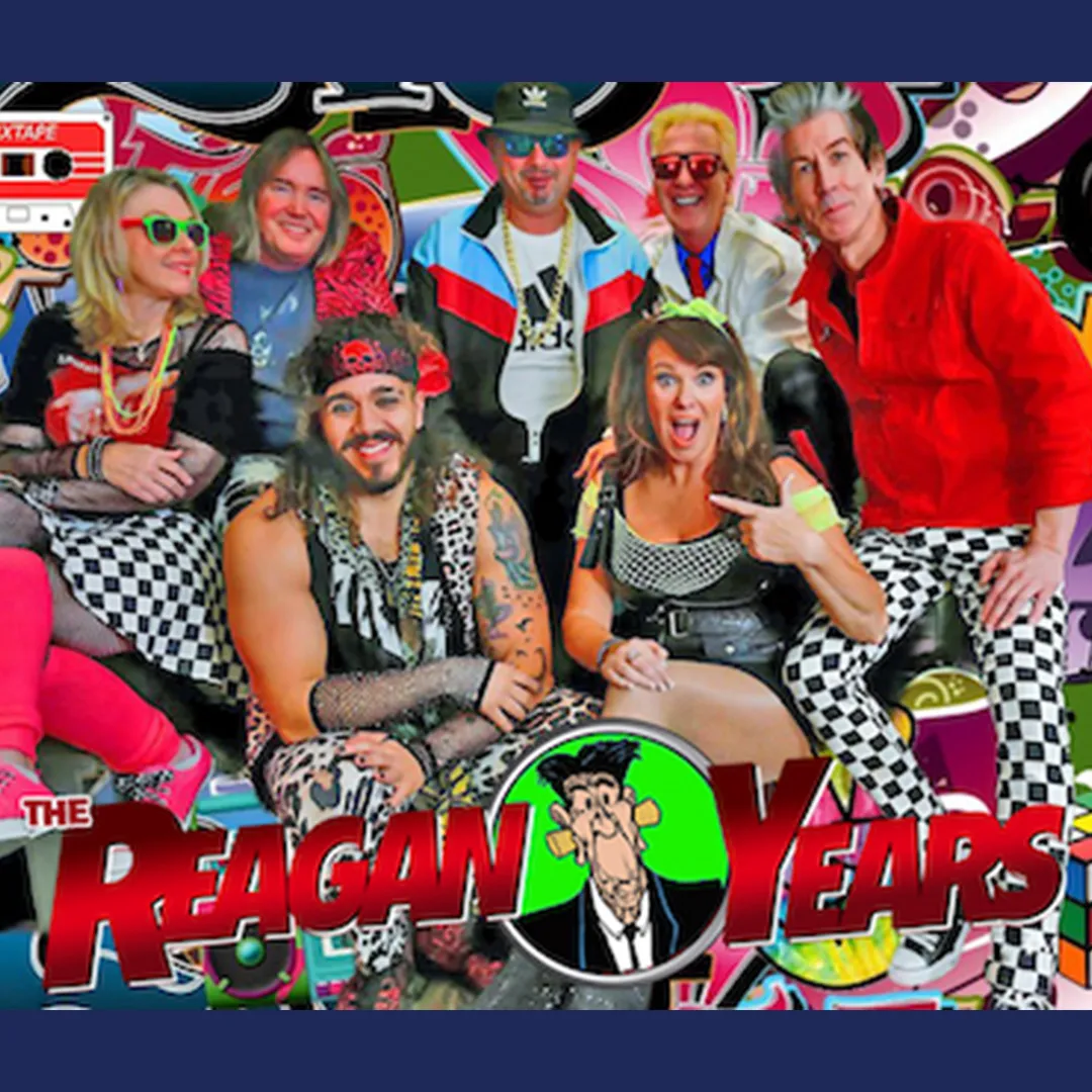 A group of seven people in colorful, retro 1980s outfits pose in front of a bright, patterned backdrop with "The Reagan Years" text at the bottom.