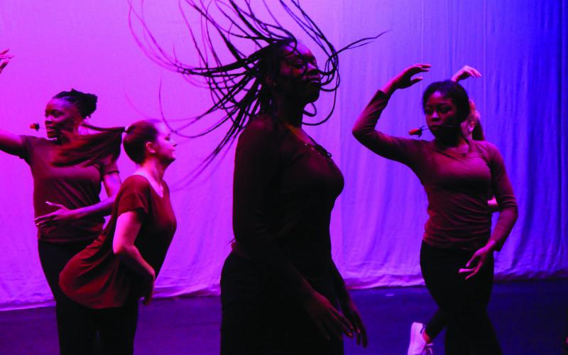 Five students dancing on stage