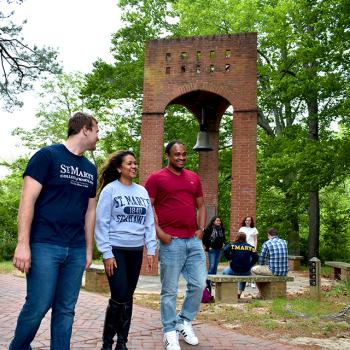 SMCM students walk by the bell tower on campus 