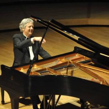 Pianist Brian Ganz performing piano at a recital