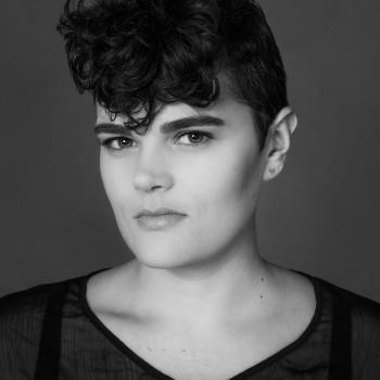 Jeanette Marie Warren, vocalist, singer, and performance artist posing for a headshot