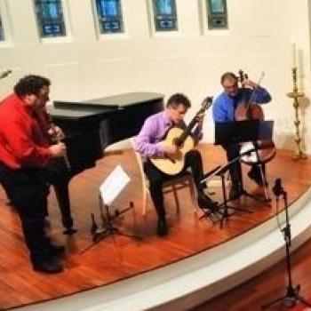 The Clazzical Project after a concert, featuring three male instrumentalists