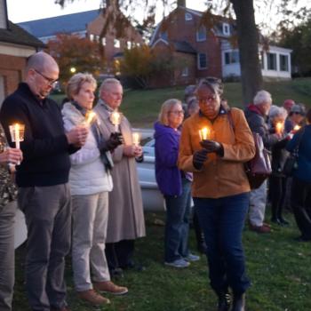 The lives of those enslaved were honored with a reading of their names, candle lighting, celebration, libation, remembrance and reflection at the Waterfront Ceremony. Dr Jordan and guests pictured holding candles. 