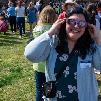 Meg Chee wearing eclipse viewing glasses