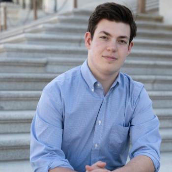 Portrait of Henry Marks sitting on steps outdoors 