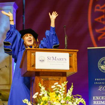President Rhonda Phillips, smiling with arms raised, during the 2026 presidential inauguration at St. Mary's College of Maryland.