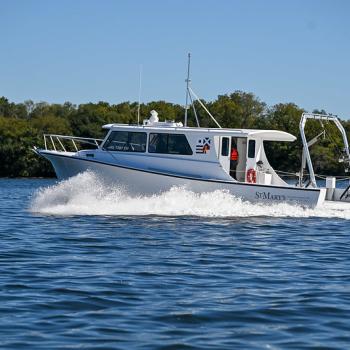 A white St. Mary’s research vessel cruising across open water.