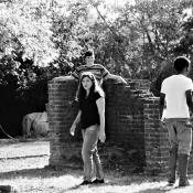 A photo of Dr. Steiger directing Macbeth in 2019 outdoors at Historic St. Mary's City surrounded by two student actors. Photo credit Chloe Colvin.